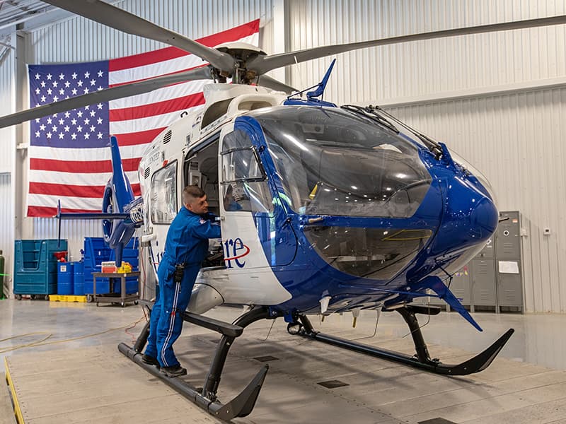 Paul Boackle, a flight nurse with AirCare, readies the helicopter for its next trip while it's temporarily parked at the new MCES building.
